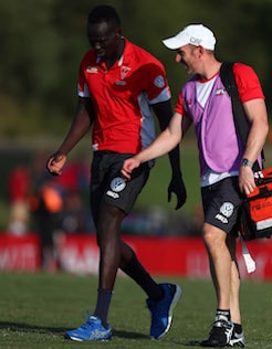 AFL 2018 JLT Community Series - Brisbane v Sydney BRISBANE, AUSTRALIA - MARCH 03: Aliir Aliir of the Swans walks with a physio during the AFL JLT Community Series match between the Brisbane Lions and the Sydney Swans at Moreton Bay Central Sports Complex on March 3, 2018 in Brisbane, Australia. (Photo by Chris Hyde/Getty Images/AFL/Media)